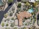 Expansive aerial view of a home nestled within desert vegetation showcasing it's large terra cotta tile roof and pool at 4747 E Arroyo Verde Dr, Paradise Valley, AZ 85253