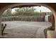 Long stone paved driveway with desert landscaping, wooden gates, accent lighting and arched entryway at 4747 E Arroyo Verde Dr, Paradise Valley, AZ 85253