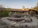 Outdoor gathering space featuring a firepit with seating, surrounded by rocks and desert plants at 4747 E Arroyo Verde Dr, Paradise Valley, AZ 85253