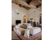 Spacious living room featuring a Saltillo tile floor, exposed beam ceiling, and a comfortable seating area at 4747 E Arroyo Verde Dr, Paradise Valley, AZ 85253