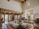 Bright living room boasts exposed beams, fireplace, Saltillo tile flooring, and stylish decor at 4747 E Arroyo Verde Dr, Paradise Valley, AZ 85253