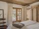 Bright main bedroom featuring wood ceiling, and french doors leading to the outside at 4747 E Arroyo Verde Dr, Paradise Valley, AZ 85253
