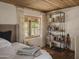 Inviting bedroom with wood ceiling, shelving unit, and a large sunny window at 4747 E Arroyo Verde Dr, Paradise Valley, AZ 85253