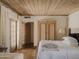 Comfortable bedroom with wood ceiling, wardrobe, and french door leading to outside at 4747 E Arroyo Verde Dr, Paradise Valley, AZ 85253
