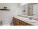 A traditional bathroom with an elongated vanity with a marble countertop and an oval sink at 4854 E Evergreen St, Mesa, AZ 85205