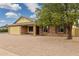 View of the home's charming brick facade, two car garage, and neutral landscaping at 4854 E Evergreen St, Mesa, AZ 85205