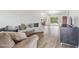 Open-concept living room boasts wood-look flooring, neutral color palette, and ample natural light at 4854 E Evergreen St, Mesa, AZ 85205