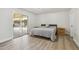 A cozy bedroom with hardwood floors, a grey bed and sliding glass doors at 4854 E Evergreen St, Mesa, AZ 85205