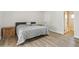 A spacious main bedroom features hardwood floors, a door to the ensuite, and a grey bed at 4854 E Evergreen St, Mesa, AZ 85205