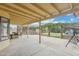 A covered patio with a dining area, a grill, and a swing at 4854 E Evergreen St, Mesa, AZ 85205