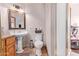 Bathroom featuring a pedestal sink, toilet, and walk-in shower at 5923 W Mauna Loa Ln, Glendale, AZ 85306