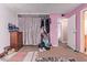 Bedroom with closet and pink walls needs a little TLC at 5923 W Mauna Loa Ln, Glendale, AZ 85306