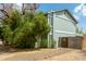 Side view of a two-story home featuring mature landscaping and a private gate at 5923 W Mauna Loa Ln, Glendale, AZ 85306