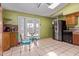 Eat-in kitchen featuring a stainless steel refrigerator, and access to the backyard at 5923 W Mauna Loa Ln, Glendale, AZ 85306