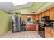 Kitchen with a skylight, granite countertops, wood cabinets and stainless steel appliances at 5923 W Mauna Loa Ln, Glendale, AZ 85306