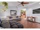 Comfortable living room featuring a large couch, table, and mounted TV at 5923 W Mauna Loa Ln, Glendale, AZ 85306