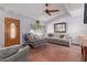 Cozy living room with a ceiling fan, wood floors, and bright natural light at 5923 W Mauna Loa Ln, Glendale, AZ 85306