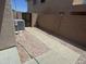 View of the backyard with a stone path, rock landscape, and a wall separating properties at 6416 N 78Th Ln, Glendale, AZ 85303