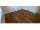 This bedroom features wood floors, white trim, and a door leading to the bathroom at 6416 N 78Th Ln, Glendale, AZ 85303