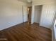 This bedroom features wood floors and a view of the bathroom and closet spaces at 6416 N 78Th Ln, Glendale, AZ 85303