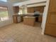 An open kitchen includes a large island, stainless steel appliances and granite countertops at 6416 N 78Th Ln, Glendale, AZ 85303
