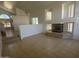 Open living area with tile floors and a fireplace, providing a warm and welcoming atmosphere at 6416 N 78Th Ln, Glendale, AZ 85303