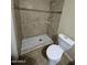 Bathroom featuring a walk-in shower with a mosaic-style wall and a white toilet at 6530 W Turney Ave, Phoenix, AZ 85033
