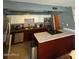 Modern kitchen with stainless steel appliances and a kitchen island cooktop at 6530 W Turney Ave, Phoenix, AZ 85033