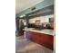 Kitchen features stainless steel appliances, kitchen island, and white cabinets at 6530 W Turney Ave, Phoenix, AZ 85033