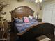 Spacious main bedroom featuring a decorative headboard, patterned bedding, and side tables at 6530 W Turney Ave, Phoenix, AZ 85033