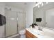 Well-lit bathroom featuring a glass shower and modern vanity at 6603 W Saddlehorn Rd, Phoenix, AZ 85083