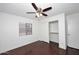 Bedroom featuring wood floors, ceiling fan, and a closet at 6603 W Saddlehorn Rd, Phoenix, AZ 85083