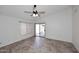 Bedroom features a ceiling fan, tile floors, a sliding glass door to the backyard at 6603 W Saddlehorn Rd, Phoenix, AZ 85083