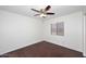 Cozy bedroom with wood floor, ceiling fan, and backyard view at 6603 W Saddlehorn Rd, Phoenix, AZ 85083