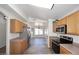 Spacious kitchen with stainless steel appliances, wood cabinets, and open layout to dining area at 6603 W Saddlehorn Rd, Phoenix, AZ 85083