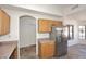 Well-lit kitchen featuring wood cabinetry, modern appliances, and an adjacent dining area at 6603 W Saddlehorn Rd, Phoenix, AZ 85083