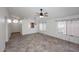 Bright living room featuring tile floors, large windows with sheer curtains, and modern lighting fixtures at 6603 W Saddlehorn Rd, Phoenix, AZ 85083