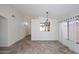 Open living area with neutral walls, tile flooring, and stylish light fixtures at 6603 W Saddlehorn Rd, Phoenix, AZ 85083