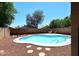 Kidney shaped pool surrounded by desert landscaping, creating a private backyard oasis at 6603 W Saddlehorn Rd, Phoenix, AZ 85083