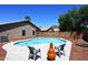 Inviting backyard features a sparkling pool, mature landscaping, and a cozy fire pit at 6603 W Saddlehorn Rd, Phoenix, AZ 85083