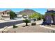 Scenic street view with mountain backdrop, showcasing the community's natural beauty at 6603 W Saddlehorn Rd, Phoenix, AZ 85083