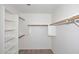 Bright walk-in closet with built-in shelving and wood closet rod at 6603 W Saddlehorn Rd, Phoenix, AZ 85083