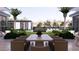 Backyard featuring a large outdoor table, seating area, and manicured landscaping with a swimming pool in the distance at 6649 E Ocotillo Rd, Paradise Valley, AZ 85253