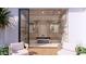 Modern bathroom with glass doors, dual vanities, standalone tub, and contemporary fixtures, blending style and comfort at 6649 E Ocotillo Rd, Paradise Valley, AZ 85253