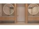 Modern bathroom featuring double sinks, large mirrors, and sleek design with clean lines at 6649 E Ocotillo Rd, Paradise Valley, AZ 85253