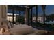 Bedroom with stunning views of the pool and landscaped grounds through expansive glass windows at 6649 E Ocotillo Rd, Paradise Valley, AZ 85253