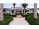 Stunning front entrance with well manicured landscaping and palm trees at 6649 E Ocotillo Rd, Paradise Valley, AZ 85253