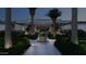 Inviting front entrance with a manicured landscape and palm trees leading to a modern home exterior at dusk at 6649 E Ocotillo Rd, Paradise Valley, AZ 85253