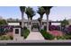 Beautiful contemporary home featuring manicured landscaping with palm trees and colorful plantings at 6649 E Ocotillo Rd, Paradise Valley, AZ 85253