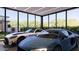 Spacious garage showcasing two luxury vehicles, with ample lighting and large glass windows at 6649 E Ocotillo Rd, Paradise Valley, AZ 85253